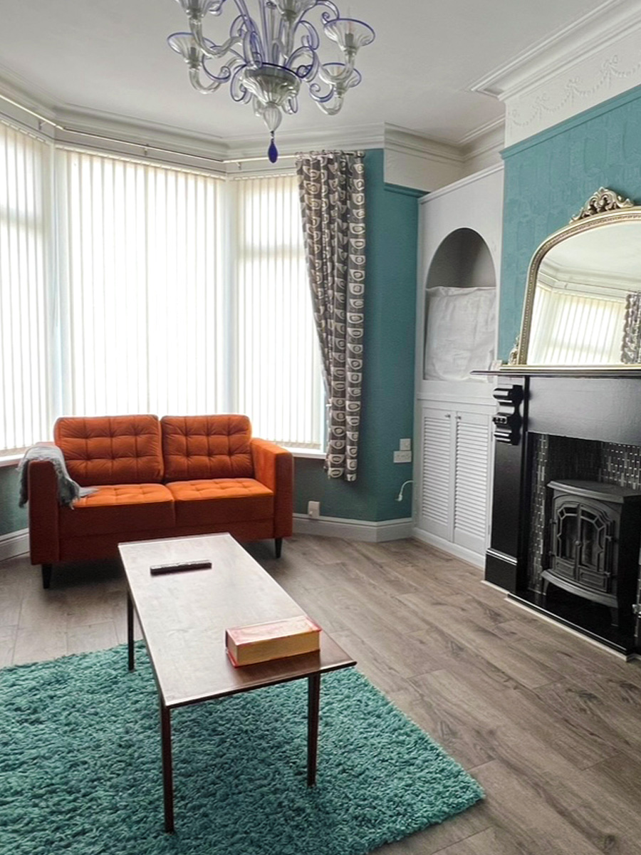 orange sofa with aqua blue rug